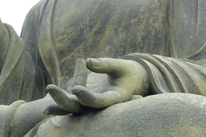 male likeness, solid, no people, korea, spiritual, representation, religion, day, deity, stone, meditation, outdoors, stone material, hand, close-up, sculpture