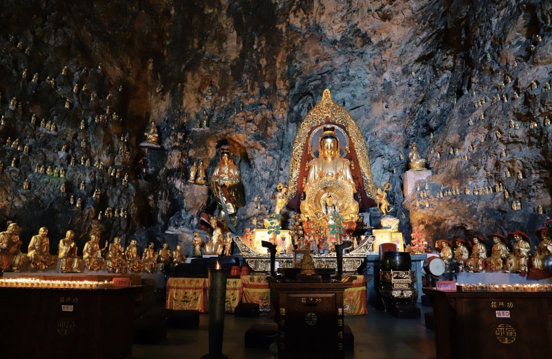 dark, religion, indoors, lot, mood, shiny, art and craft, temple, statue, built structure, gold, buddha, travel destinations, idol, no people, hindu, landscape