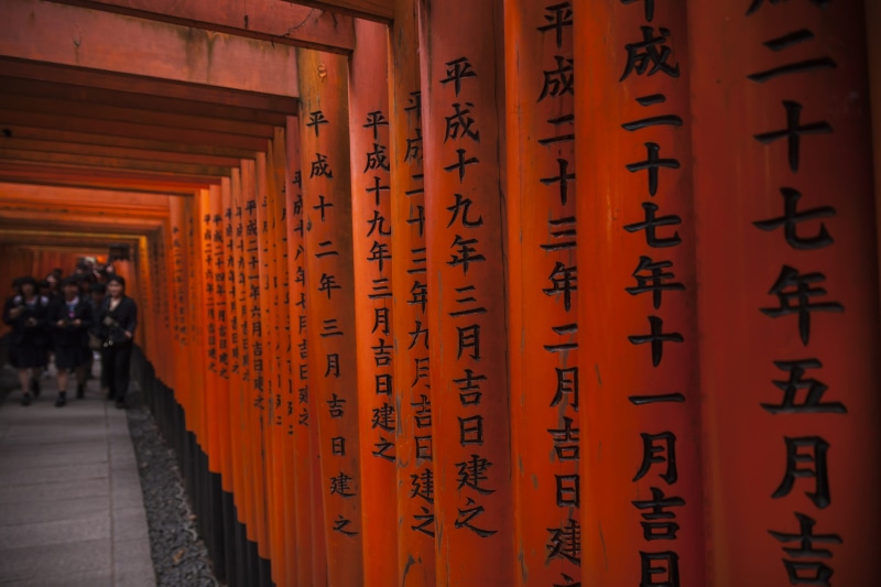 religion, spirituality, tourism, road, belief, brown, church, red, architectural column, human, column, communication, in a row, pagoda, corridor, wall