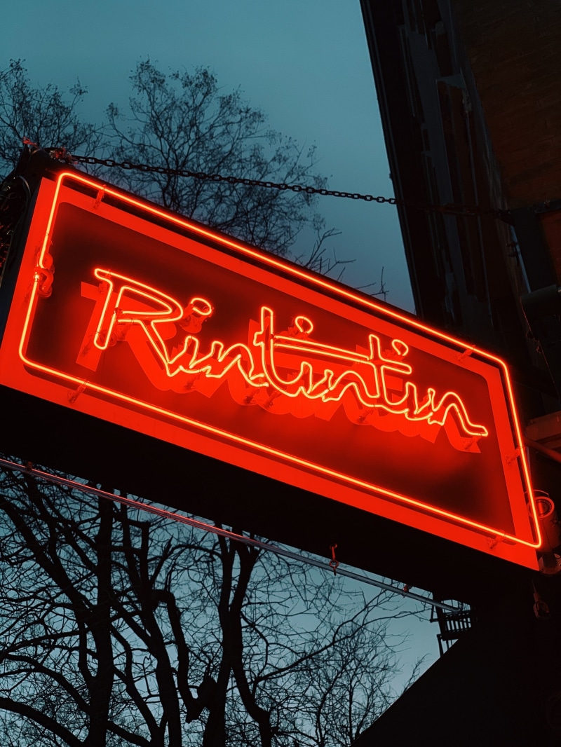 food, western script, text, nature, building, plant, road sign, meal, handrail, red, night, diner, signage, cafe, light, restaurant, flare, banister, no people