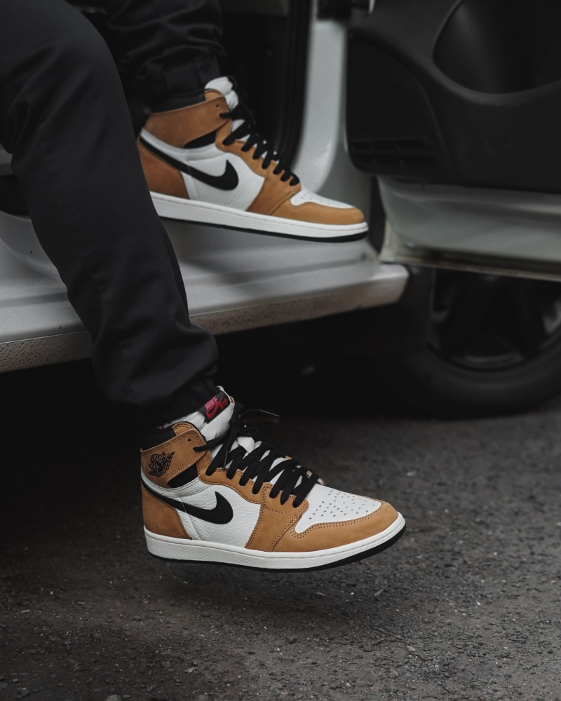 day, spoke, brown, arts culture and entertainment, holding, human foot, human, tire, sneaker, high angle view, low section, machine, clothing, shoelace