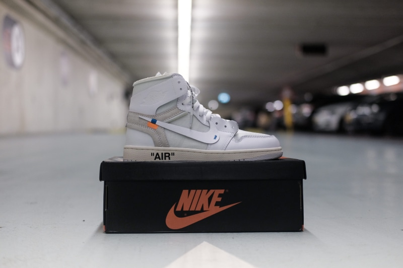 flooring, footwear, close-up, western script, transportation, obscured face, top, crash helmet, sign, white, text, helmet, high, indoors, coat, illuminated