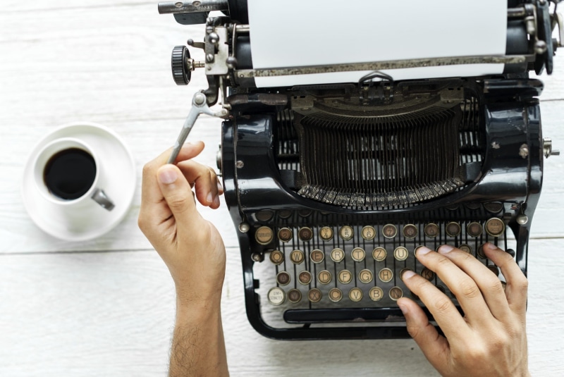 work, human body part, analog, writer, side, finger, indoors, using, type, table, keyboard, background, hobby, beverage, hot drink, lancer, enjoying, vintage