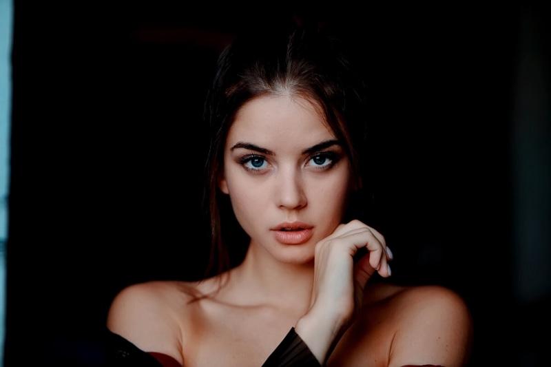looking at camera, beauty, women, 1080P, lifestyles, young women, painted nails, headshot, brunette, fashion, black background, bare shoulders, young adult