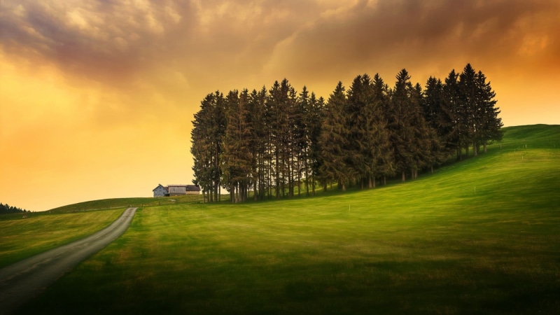 idyllic, nature, lawn, beauty in nature, non-urban scene, house, environment, sunset, hills, no people, grass, clouds, outdoors, tranquility, green color