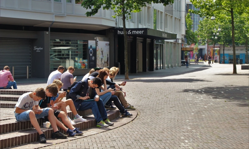 city life, young, leisure activity, information, academic, sitting, lifestyles, nature, wireless, day, street, electronics, tall, word, group of people
