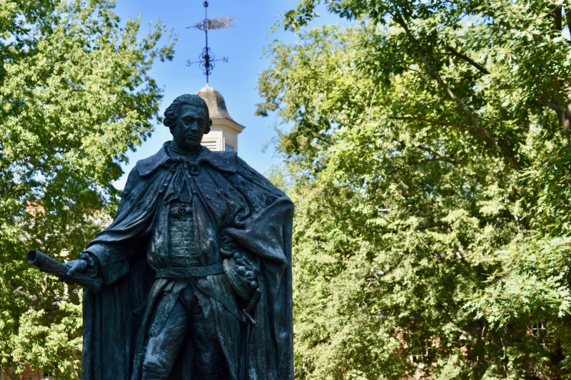 craft, grass, area, human representation, w m, wren, nature, monument, sculpture, male likeness, williamsburg, blue, lord, outdoors, trees, college, tourist