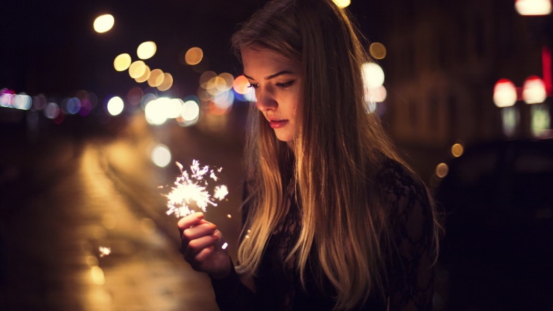 holding, night, women outdoors, blonde, lifestyles, lights, sparkles, black clothing, top, sparkler, s, hair, city street, young women, adult, open mouth