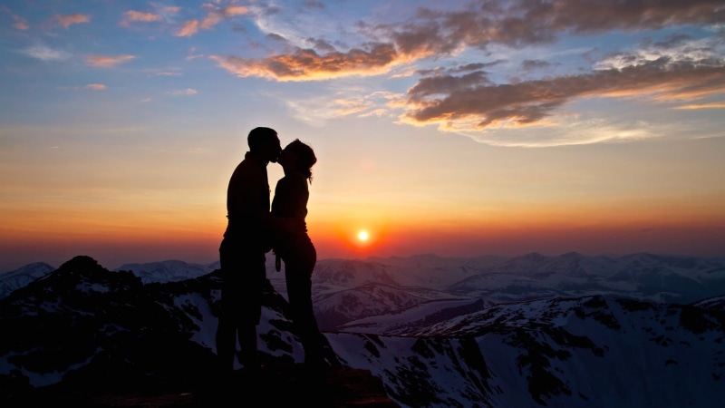 lifestyles, adult, tranquil scene, bonding, cloud - sky, kissing, lovers, orange color, togetherness, silhouette, sky, men, beauty in nature, couple - relationship