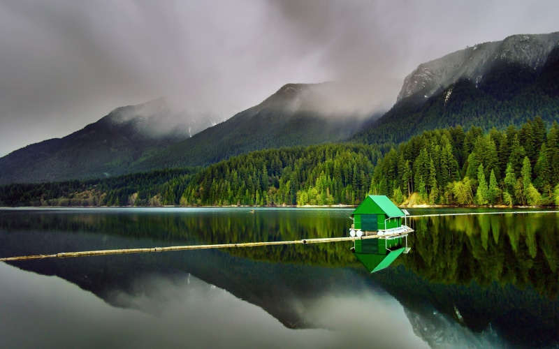 tranquil scene, forest, mode of transportation, floating, no people, nature, nautical vessel, beauty in nature, boat, green color, mountain, sky, reflection