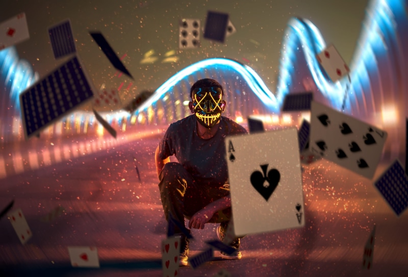 live performance, gambling, night photography, mask, ground, performance, long exposure, recreation, technology, symbol, red, cards, text, holding, Joker