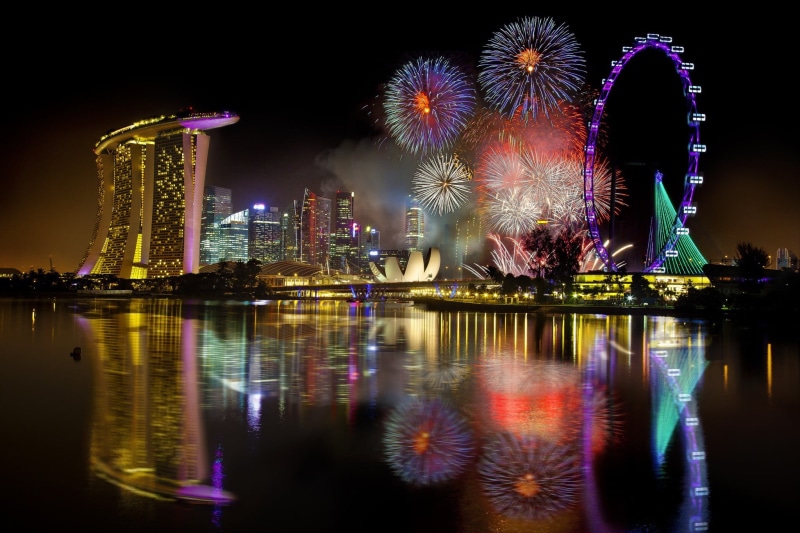 skyscraper, motion, multi colored, sands, modern, illuminated, water, waterfront, arts culture and entertainment, bay, nightlife, marina, firework - man made object