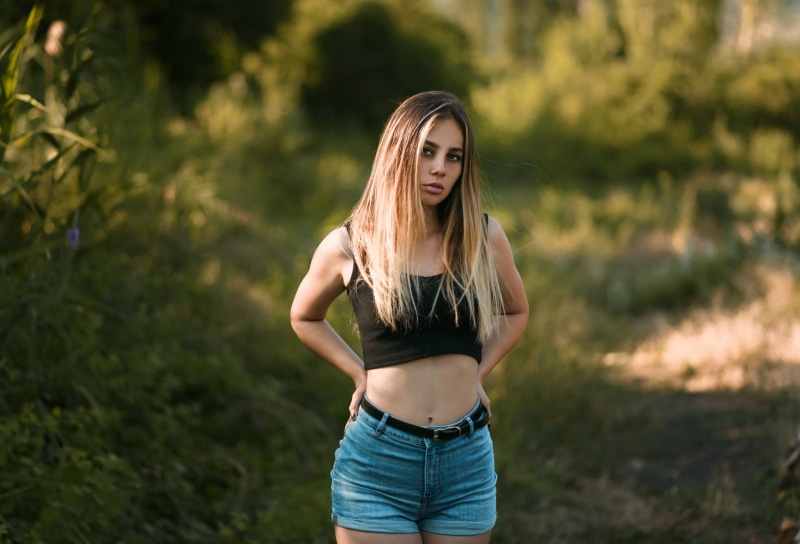 day, jean shorts, hairstyle, focus on foreground, belt, women, one person, standing, beautiful woman, portrait, blonde, beauty, looking at camera, hair