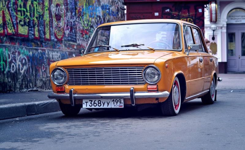penny, grille, stationary, motor vehicle, yellow, architecture, built structure, chrome, road, mode of transportation, city, graffiti, style