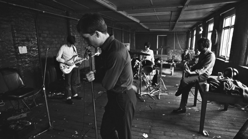 young adult, garage, music, artist, black, playing, indoors, figurine, performance, lifestyles, arts culture and entertainment, Ian Curtis, guitar, filming