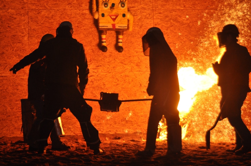 fire - natural phenomenon, orange, heat, casting, land, real people, outdoors, hot, sunset, foundry, iron, people, molten, men, nature, molten metal, melting