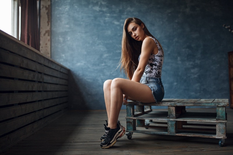 adult, tank top, one person, casual clothing, sneakers, women, brunette, looking at viewer, hair, sitting, portrait, long hair, indoors, young adult, beauty