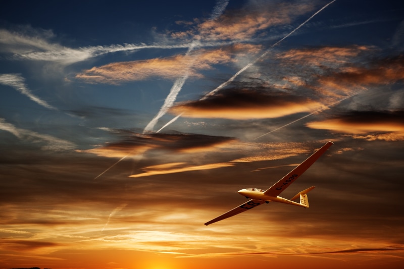 orange color, dramatic sky, outdoors, glider, flying, aerospace industry, sunset, vapor trail, scenics - nature, cloud - sky, beauty in nature, air, environment