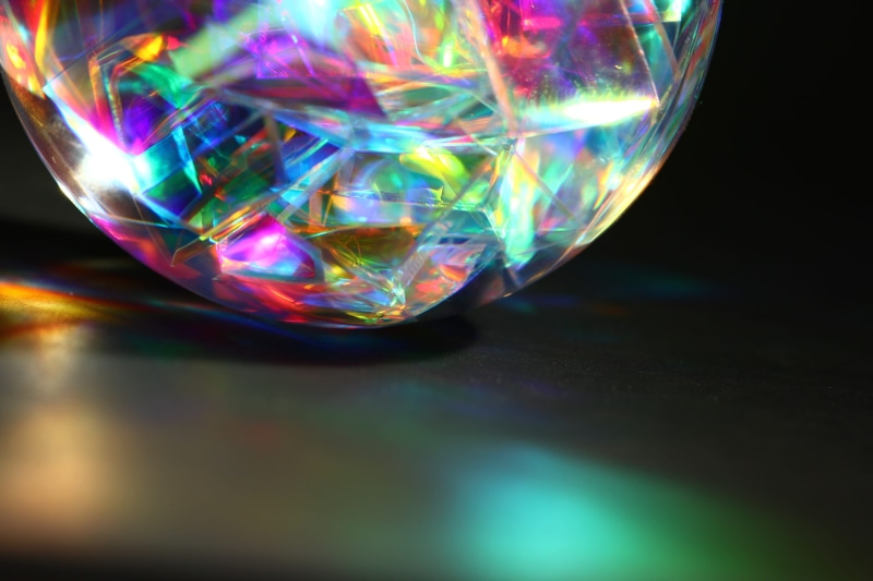 reflection, colored, shiny, focus on foreground, table, black background, multi, design, still life, no people, glowing, studio shot, spiritual, crystal