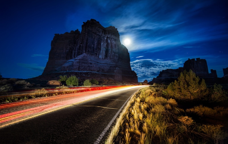 motion, no people, canyon, rock formation, travel destinations, architecture, Arches National Park, light trail, beauty in nature, surrounded, road, history