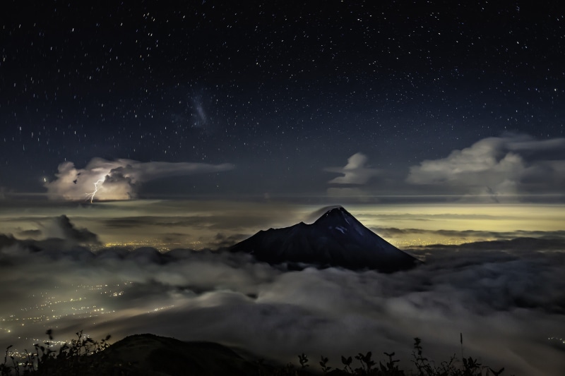 starry sky, no people, volcano, java, snowcapped mountain, nature, beauty in nature, volcanic crater, city lights, astronomy, tranquil scene, galaxy, merapi