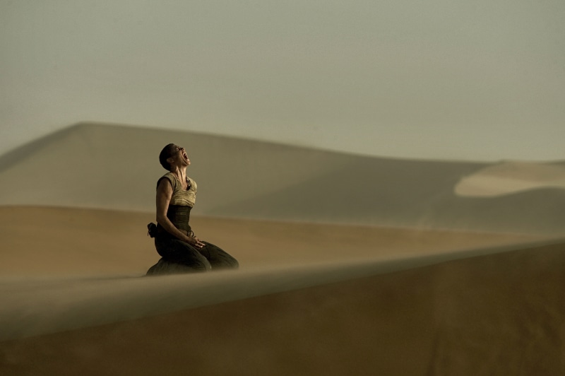 real people, desert, relaxation exercise, sand, hairstyle, women, Mad Max: Fury Road, young adult, Charlize Theron, Mad Max, leisure activity, three quarter length