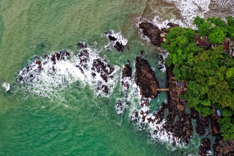 power in nature, bay, rocky shore, ocean, beauty in nature, nature photography, birds eye view, day, stones, green color, sea, solid, land, oceanside, no people
