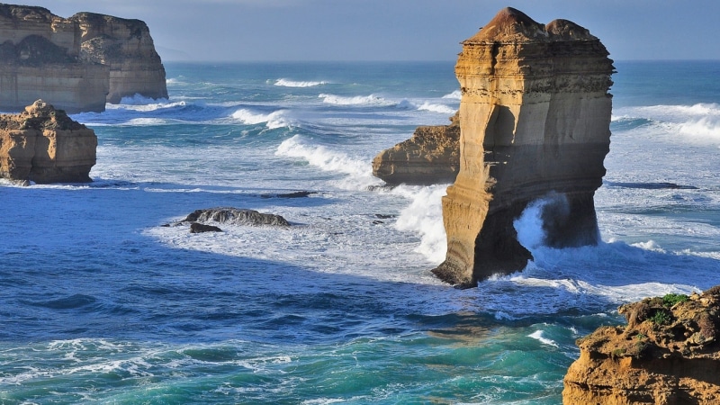aquatic sport, sea, cliff, sky, rock - object, surfing, day, horizon over water, eroded, water, land, rock formation, nature, landscape, motion, sport