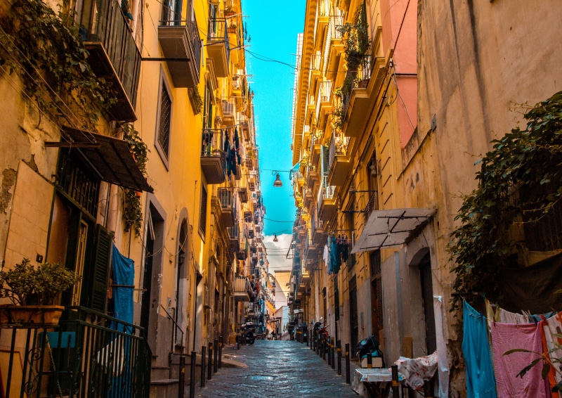 napoli, outdoors, alley, incidental people, naples, street, architecture, viewpoint, city, balcon, day, diminishing perspective, house, perspective, yellow