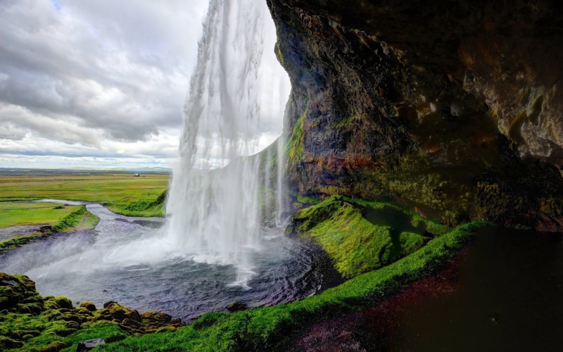 outdoors, waterfall, cloud - sky, power, flowing, plant, beauty in nature, water, land, long exposure, scenics - nature, power in nature, Seljalandsfoss Waterfall