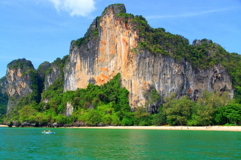 tranquil scene, tropics, solid, water, tranquility, summer, scenics - nature, waterfront, asia, coastline, beach, cliff, rock, formation, sky, green Color