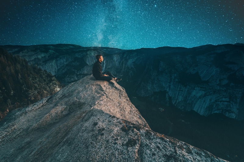 scenics - nature, young men, waterfall, rock - object, adventure, one person, non-urban scene, star, edge, real people, thinking, beauty in nature, perch