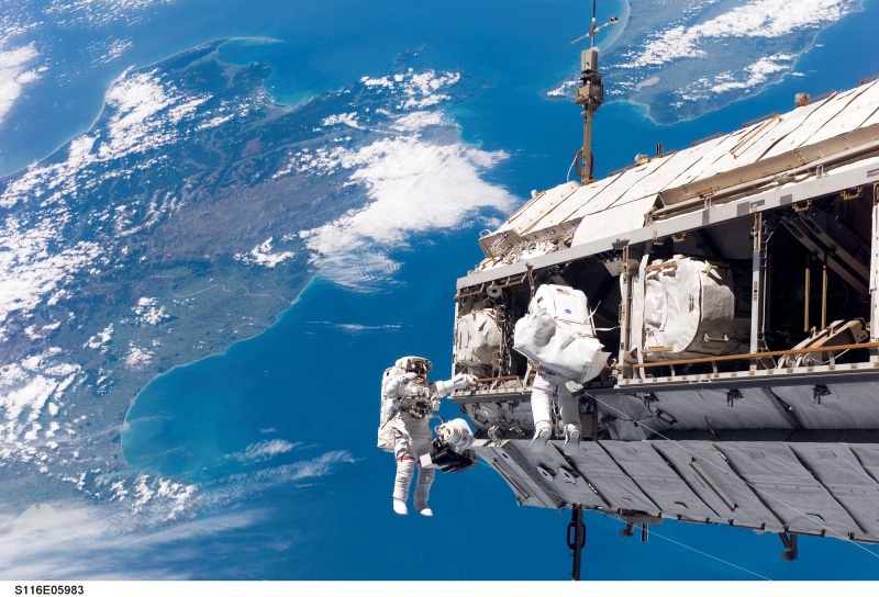 tools, real people, built structure, mid-air, building exterior, space shuttle, nature, extravehicular activity, maintenance, tether, mode of transportation