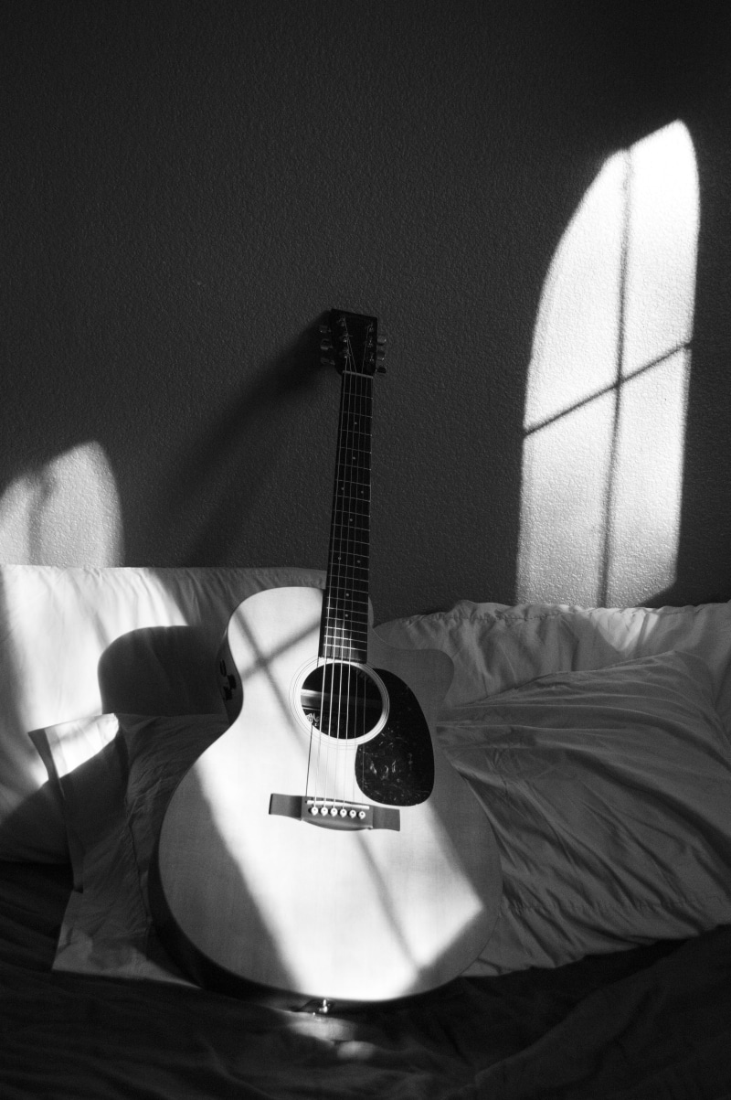 arts culture and entertainment, grey, string, string instrument, white, indoors, one person, chords, textile, strings, domestic room, pillow, 5K, sofa