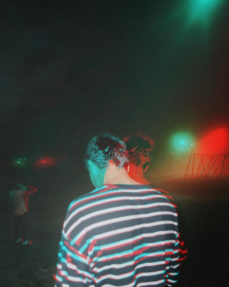 outdoors, waist up, young men, sky, vibed, park, one person, striped, lifestyles, trippy, casual clothing, fog, real people, young adult, vibes, rear view