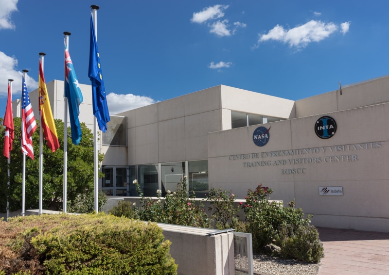 entrance, industry, flags, outdoors, building, tree, growth, architecture, no people, extraterrestrial life, flag, built structure, nature, building exterior
