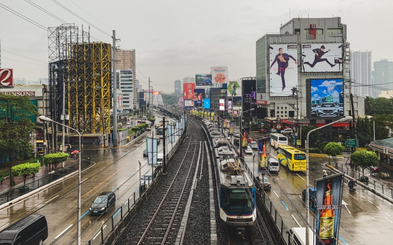 train track, automobile, train station, mode of transportation, building exterior, skyscraper, no people, railroad track, the way forward, nature, railway