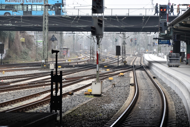 travel, transportation, railroad station, day, rail transportation, germany, human, rail, city, sign, track, train track, railroad track, electricity, signal