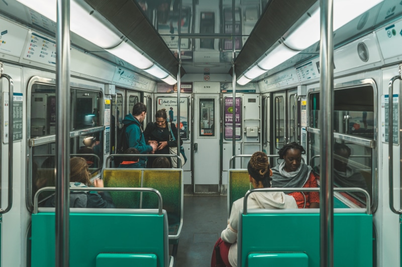 women, food, commuter, men, diner, group of people, chair, subway train, train station, human, mode of transportation, transportation, sitting, seat, public transportation