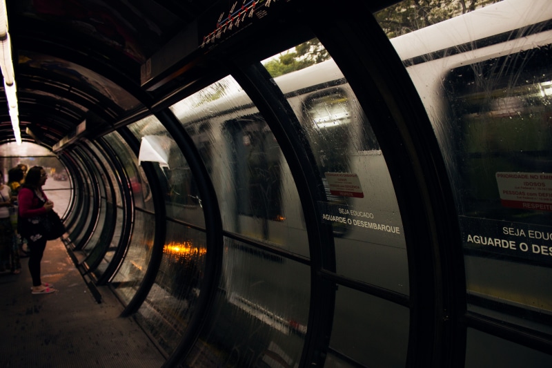 men, indoors, tunnel, glass - material, subway train, 5K, bus stop, shirt, business, mode of transportation, standing, woman, pink, train - vehicle, subway system