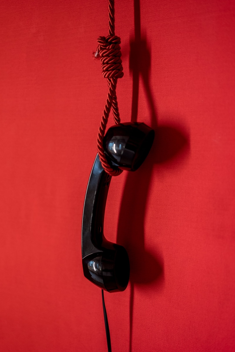 red background, metal, telephone receiver, noose, telephone, connection, hanging, suicide, colored background, close-up, pay phone, phone handset, phone
