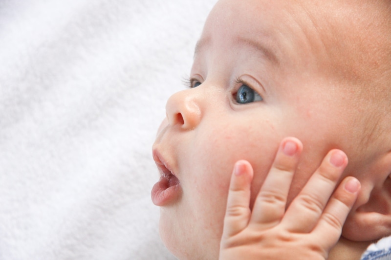 looking away, young, real people, little, laying, childhood, mouth open, face, holding, funny, happiness, newborn, babyhood, sweet, indoors, announcement