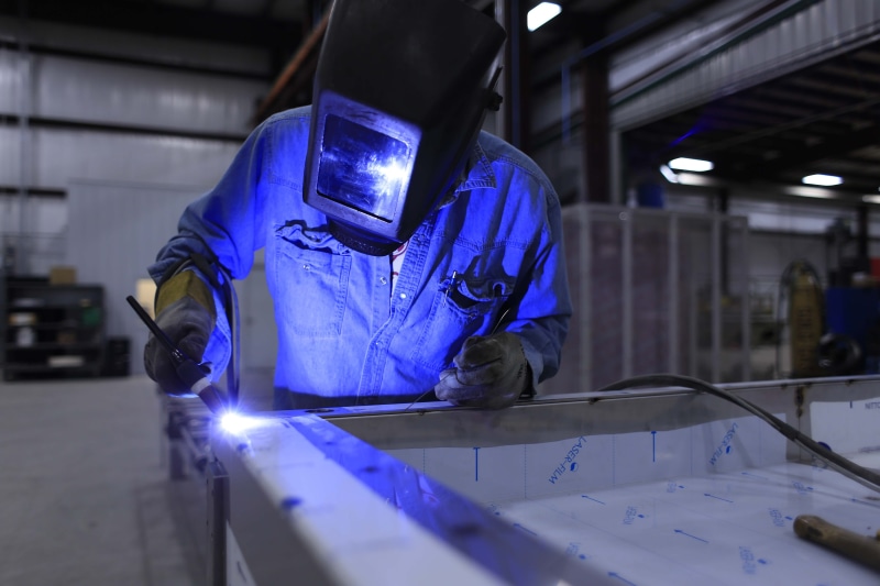 work, wearing, labor, metal, worker, one person, working, man, indoors, uniform, steel, manufacturing, occupation, construction, protection, metalwork