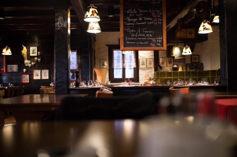 furniture, lamp, glassware, lighting equipment, food and drink, menu, dark, table, food and drink industry, communication, no people, cafe, seat, sign