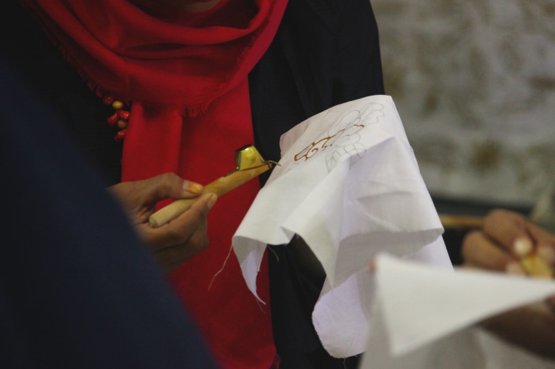 standing, finger, batik, motives, indonesia, plant, traditional clothing, process, two people, person, learning, event, culture, fabric, art, fashion, human hand