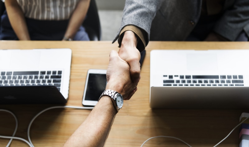 young adult, computer, meeting, macbook pro, partner, young men, working, business person, office, teamwork, using laptop, human body part, shaking, togetherness