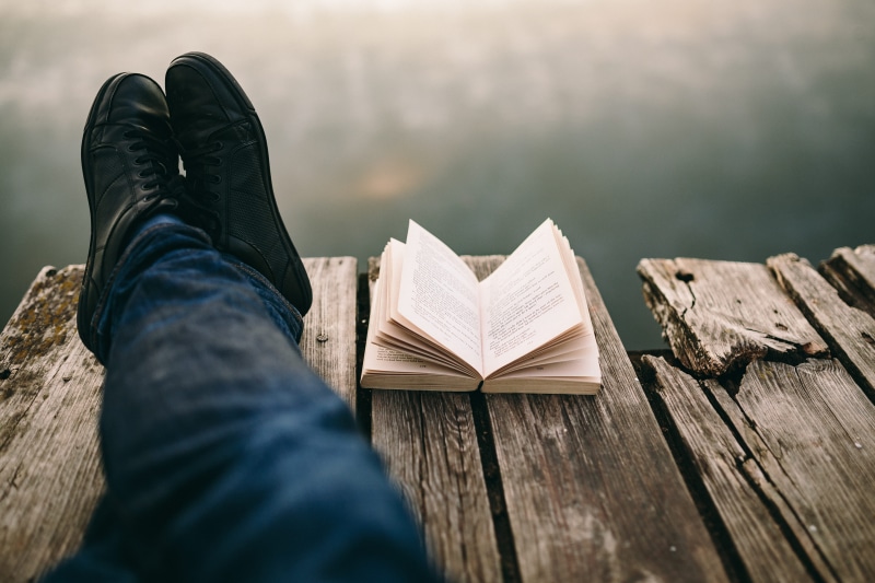 wisdom, magic hour, jeans, activity, outdoors, studying, body part, boy reading book, literature, book, low section, males, opened book, nature, woman with book