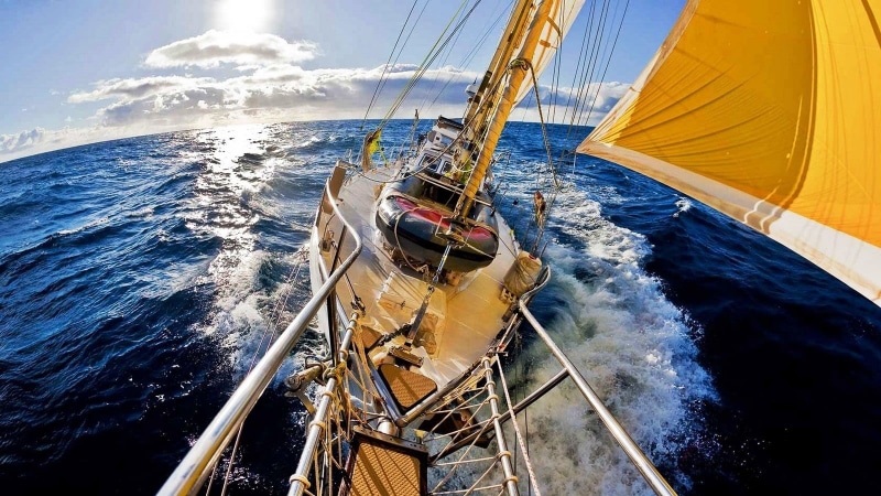 mode of transportation, boat deck, wind, yellow, white, clouds, technology, aquatic sport, brown, wheel, fisheye lens, no people, yachting, motion, sailboat