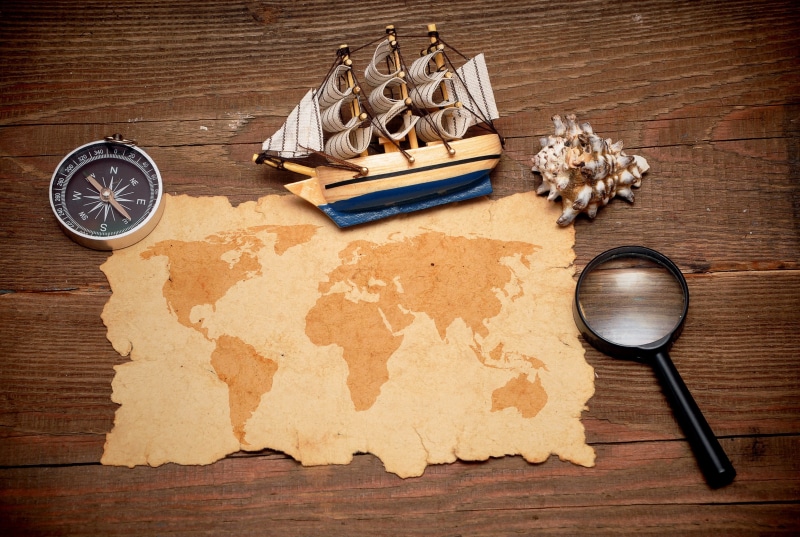 wood - material, no people, world map, high angle view, conch, book, compass, shell, food and drink, kitchen utensil, publication, preparation, indoors