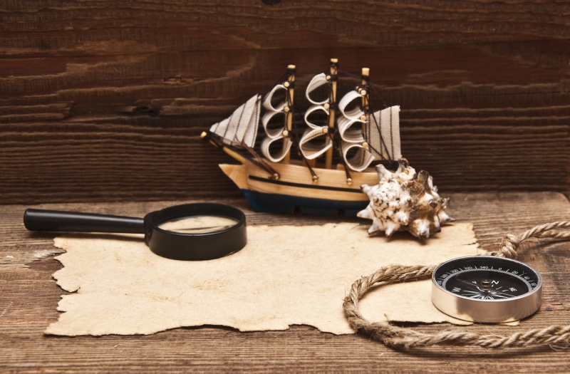 sailing ship, glass, food and drink, still life, creativity, food, miniature, sheet, high angle view, compass, mug, 2K, wood, magnifying glasses, cup